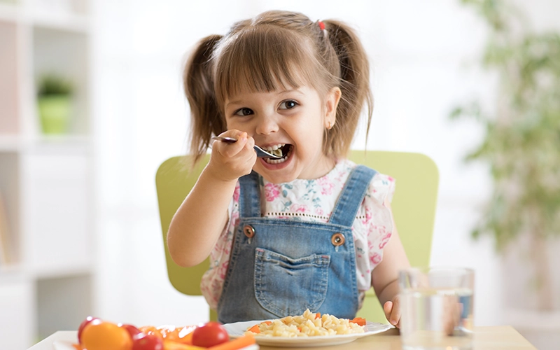 little girl eating healthy lunch